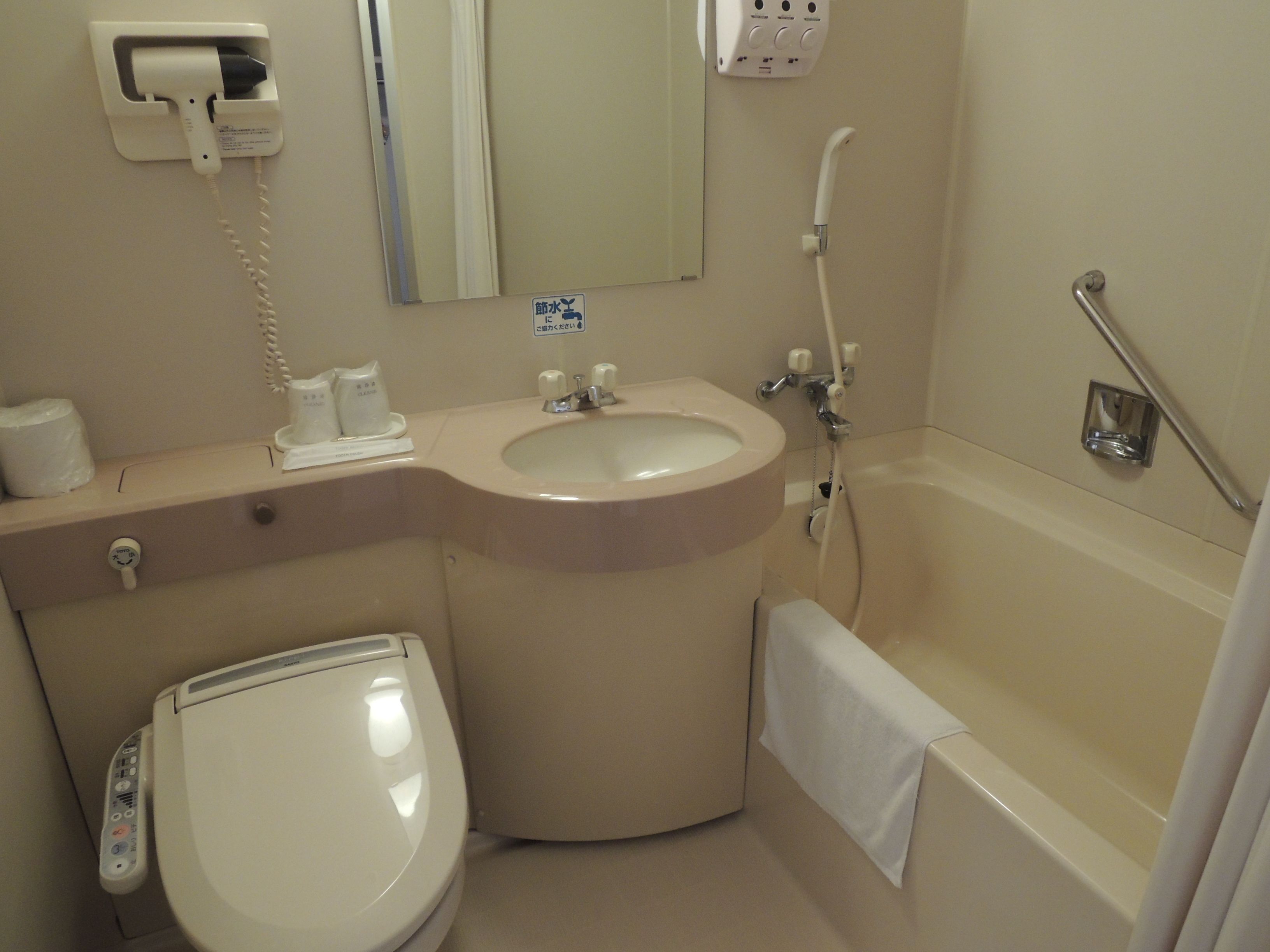 A bathroom with a toilet, sink, and bathtub.