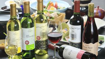 A table with various wine bottles and glasses, indicating a wine tasting event.