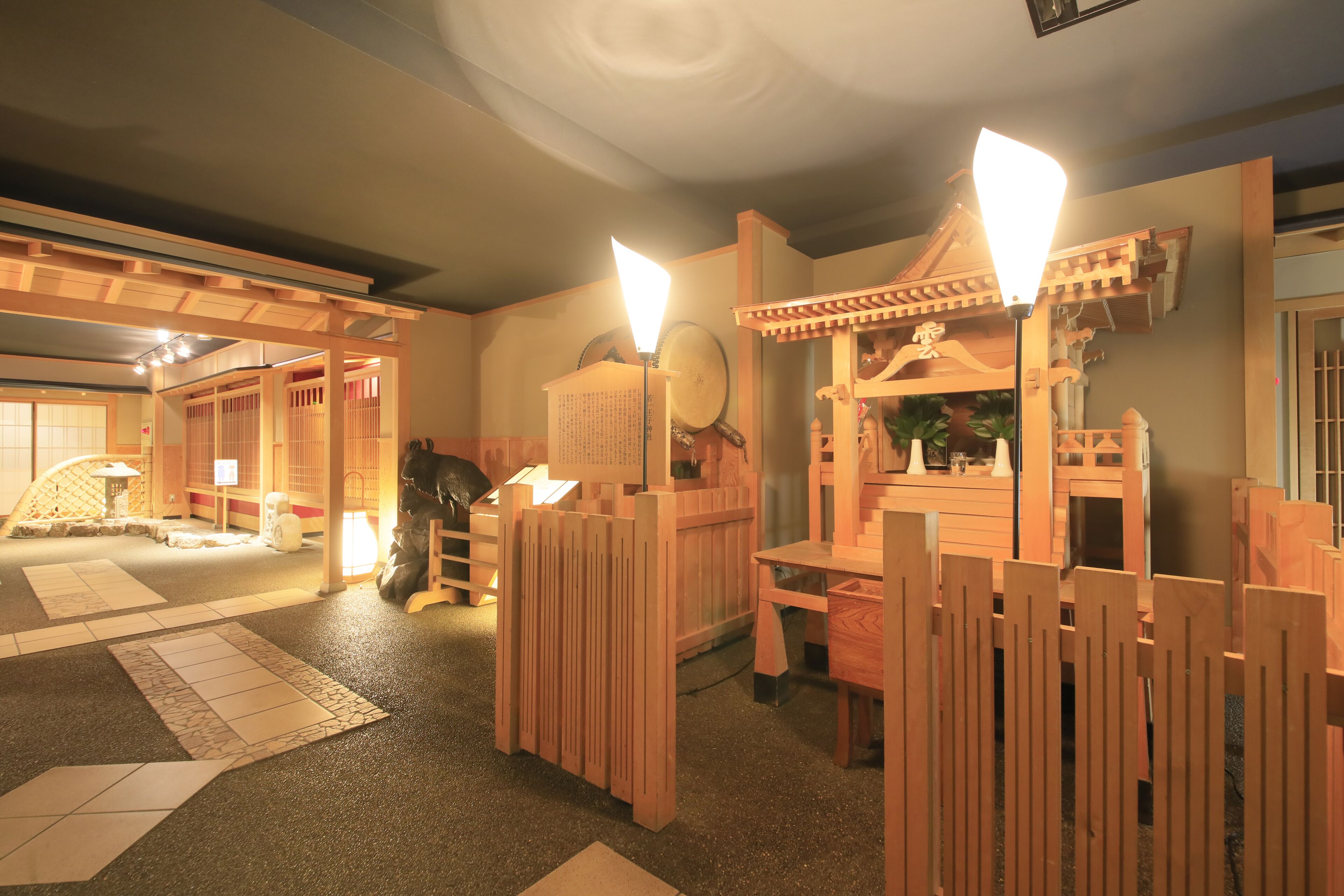 A traditional Japanese room with tatami flooring, wooden partitions, and a shoji screen.