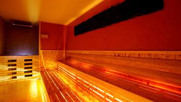 A sauna with wooden benches and a tiled floor.