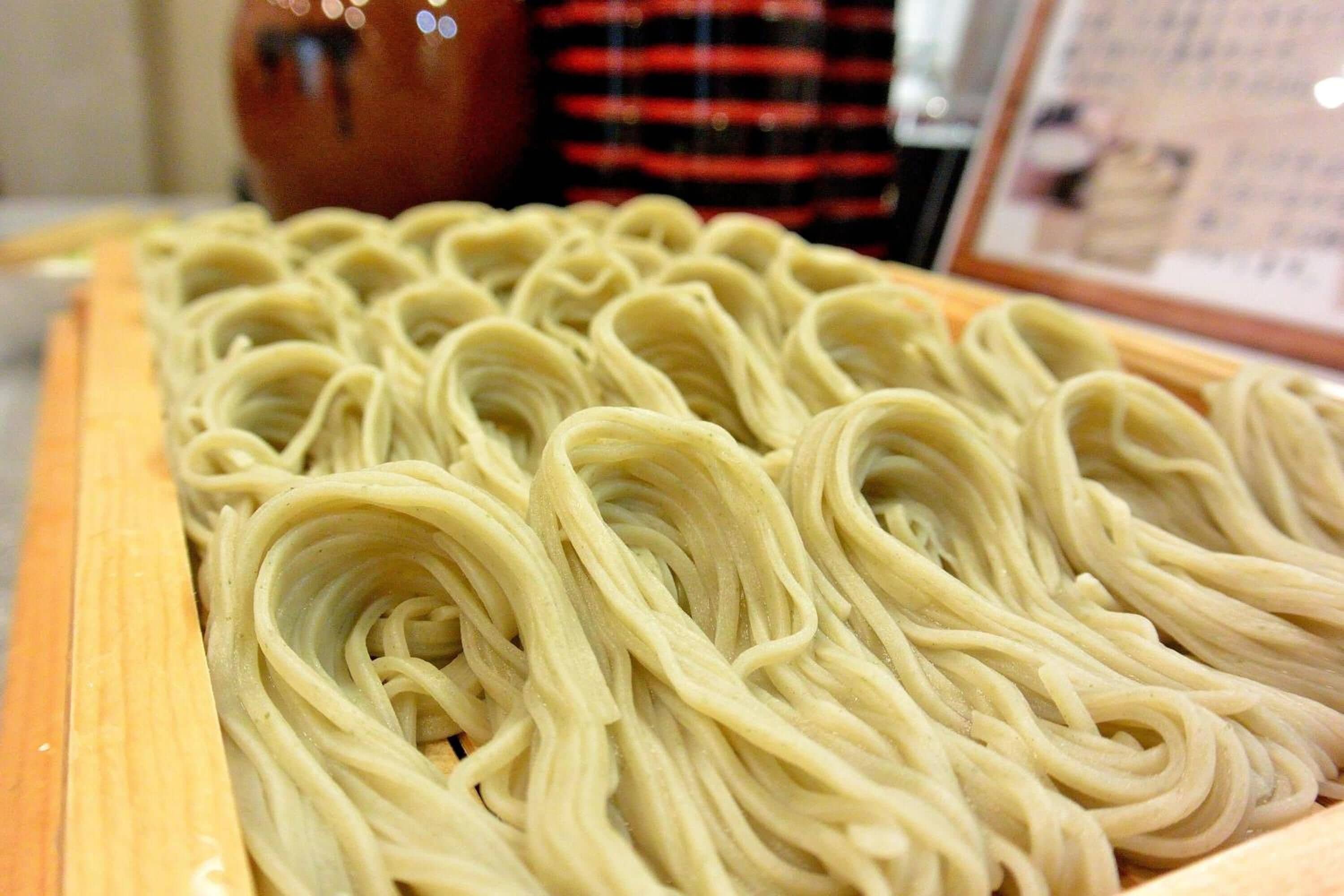 A wooden table with neatly arranged pasta.
