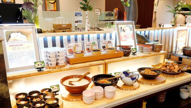 A buffet with various dishes and bowls of food.