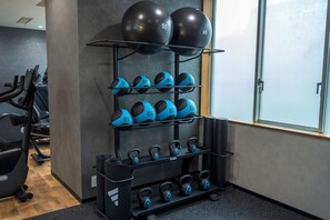 A gym with exercise equipment including dumbbells, kettlebells, and exercise balls. - Hotel Lungwood (Tokyo)