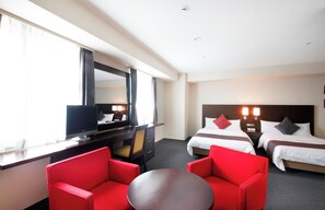 A hotel room with two beds, a desk with a computer, a TV, and red chairs. - Hotel Lungwood (Tokyo)