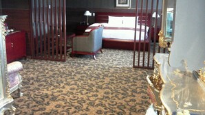 A hotel room with a patterned carpet, a bed, a desk, a chair, a dresser, and a mirror. - King Ambassador Hotel Kumagaya (Kumagaya)