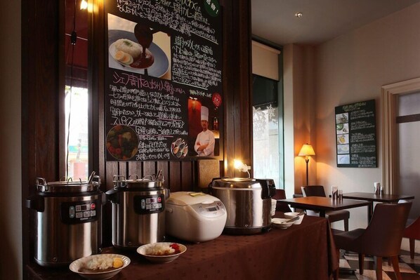 A restaurant interior with a wooden counter displaying various food items and cooking equipment. - Hotel Quest Shimizu (Shizuoka)