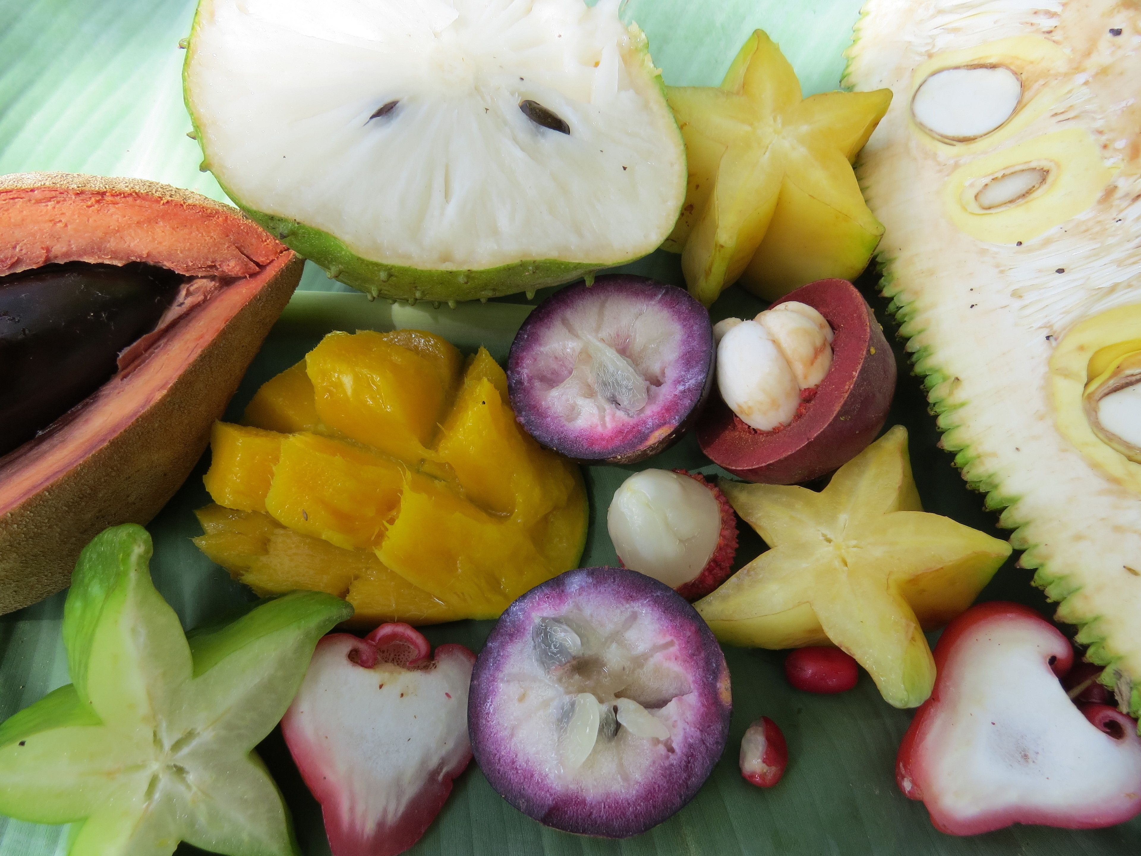 A variety of fruits including starfruit, mango, and passion fruit.