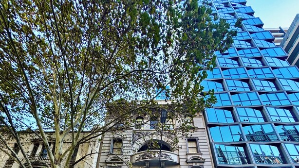 A historic building with the name "Markillies Hotel" on the facade, featuring classic architectural elements and a large tree in front. - YHA Melbourne Central (Melbourne)