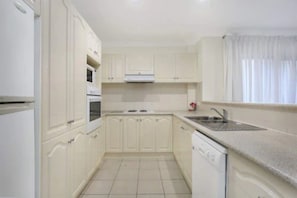 Full-size fridge, microwave, stovetop, coffee/tea maker