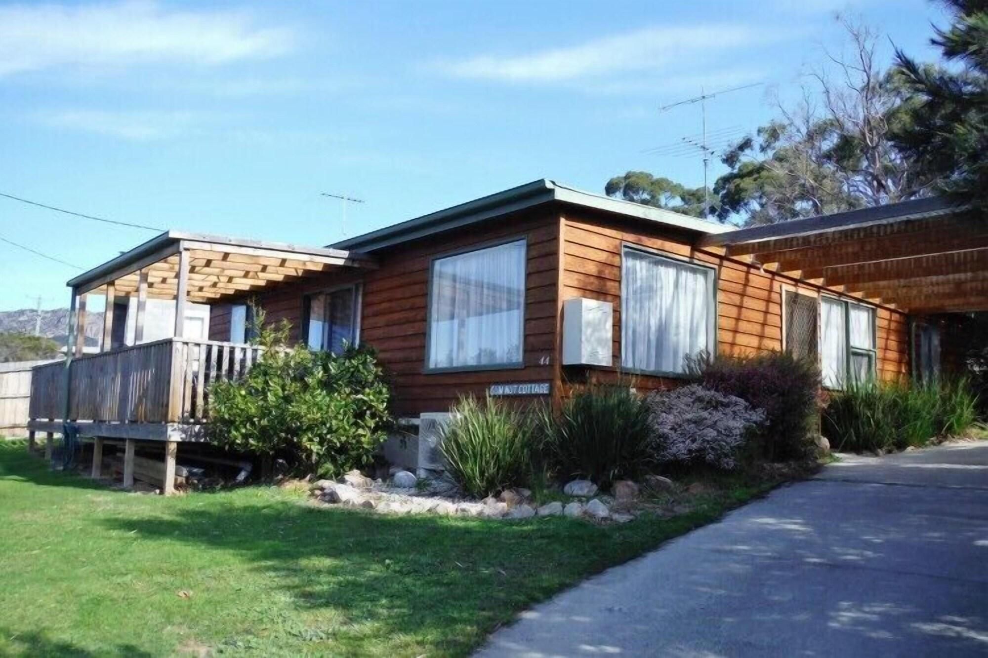A two-story mobile home with a porch and a sign indicating 'CANAST COTTAGE.'