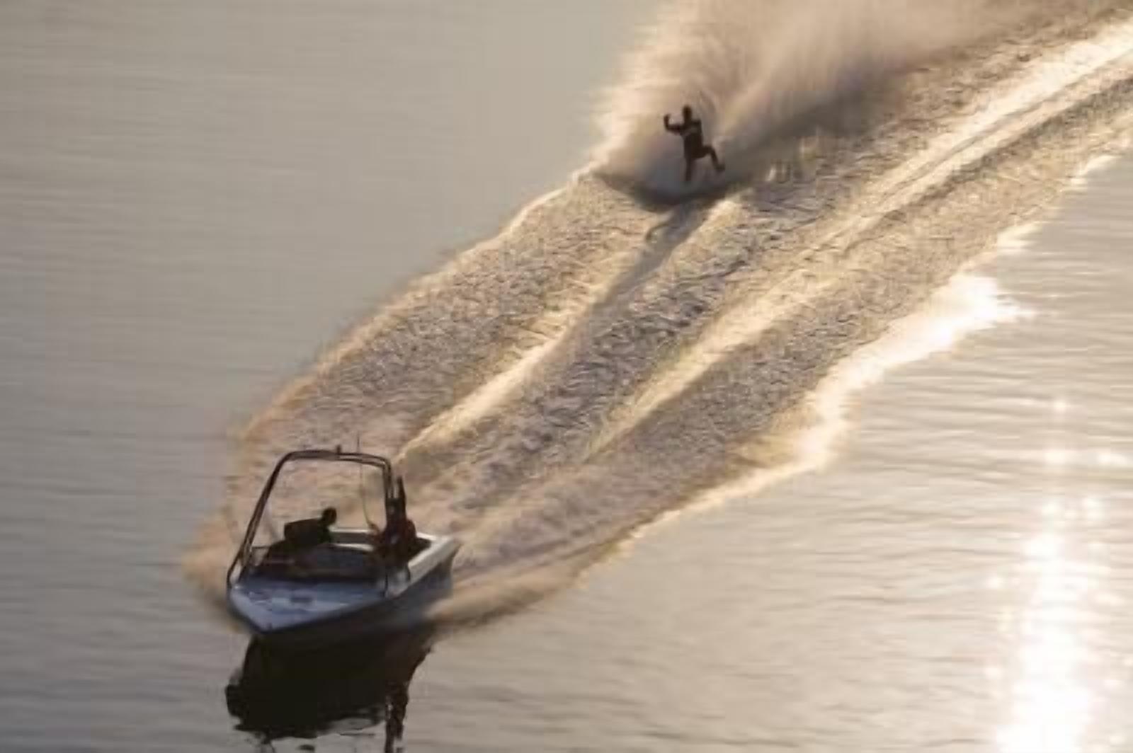 A speedboat creating a wake on a body of water.