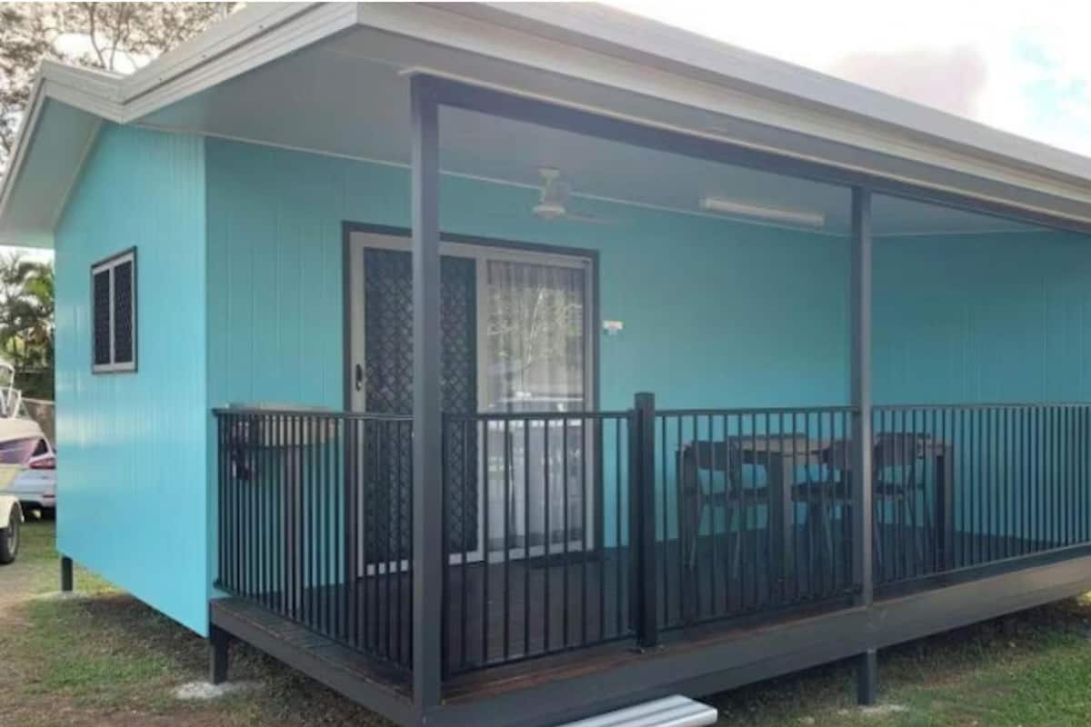 A single-story house with a covered porch, a sliding glass door, and a small patio area.