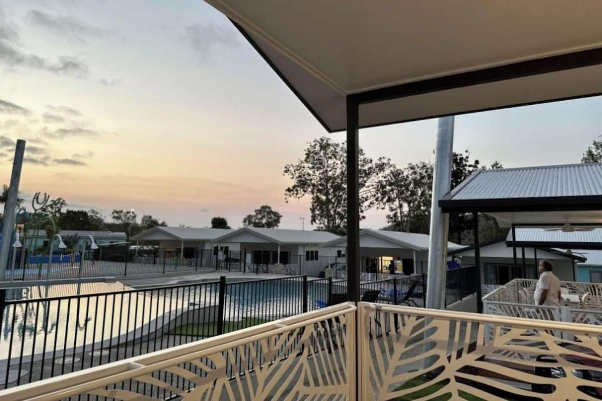 A covered outdoor area with a pool, surrounded by buildings with flat roofs.