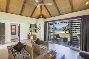 One Bedroom Beachfront Villa | Living area | Flat-screen TV
