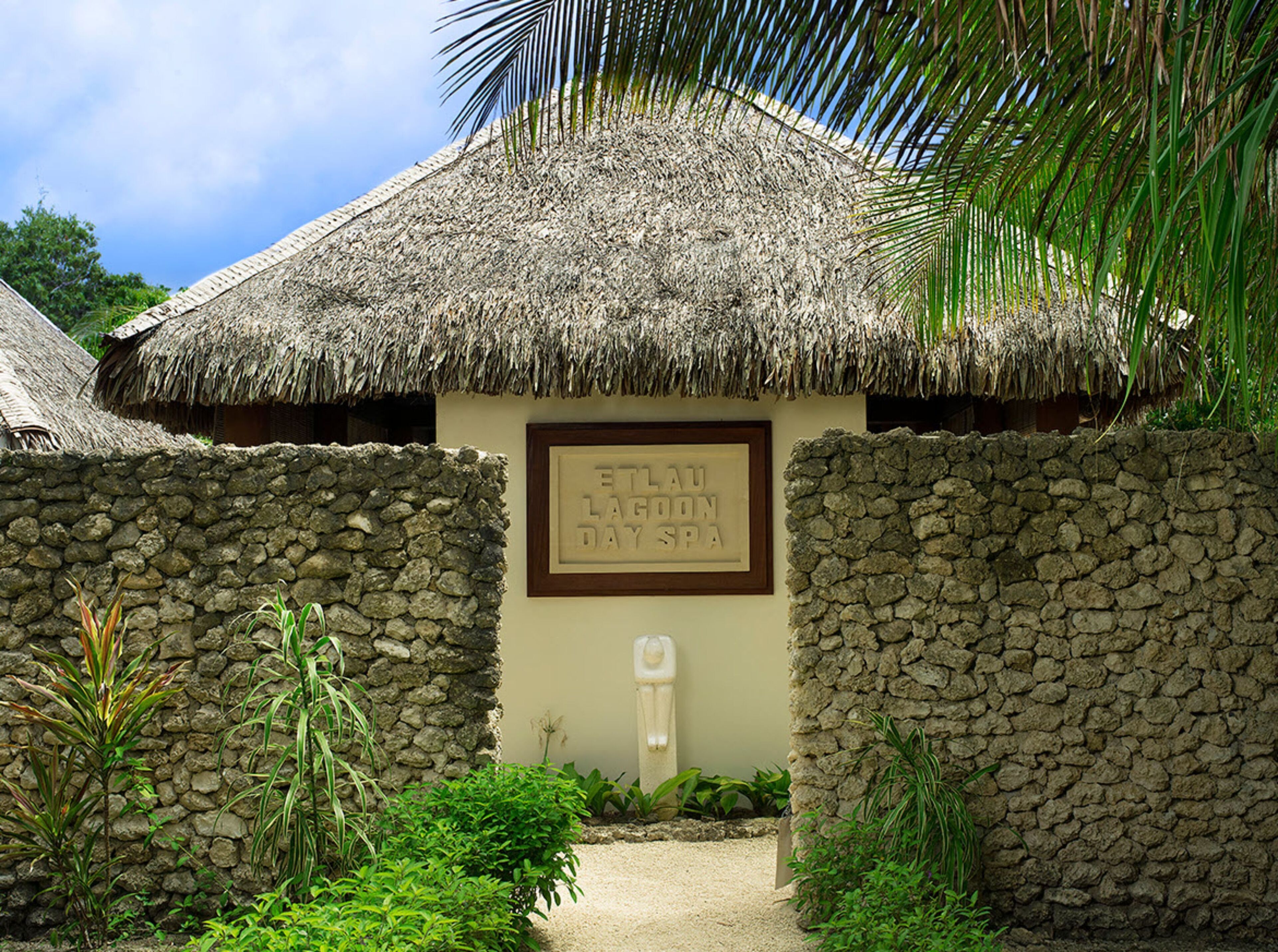 A thatched-roof building with a sign reading "ETLAU LAHOOON DAY SPA".