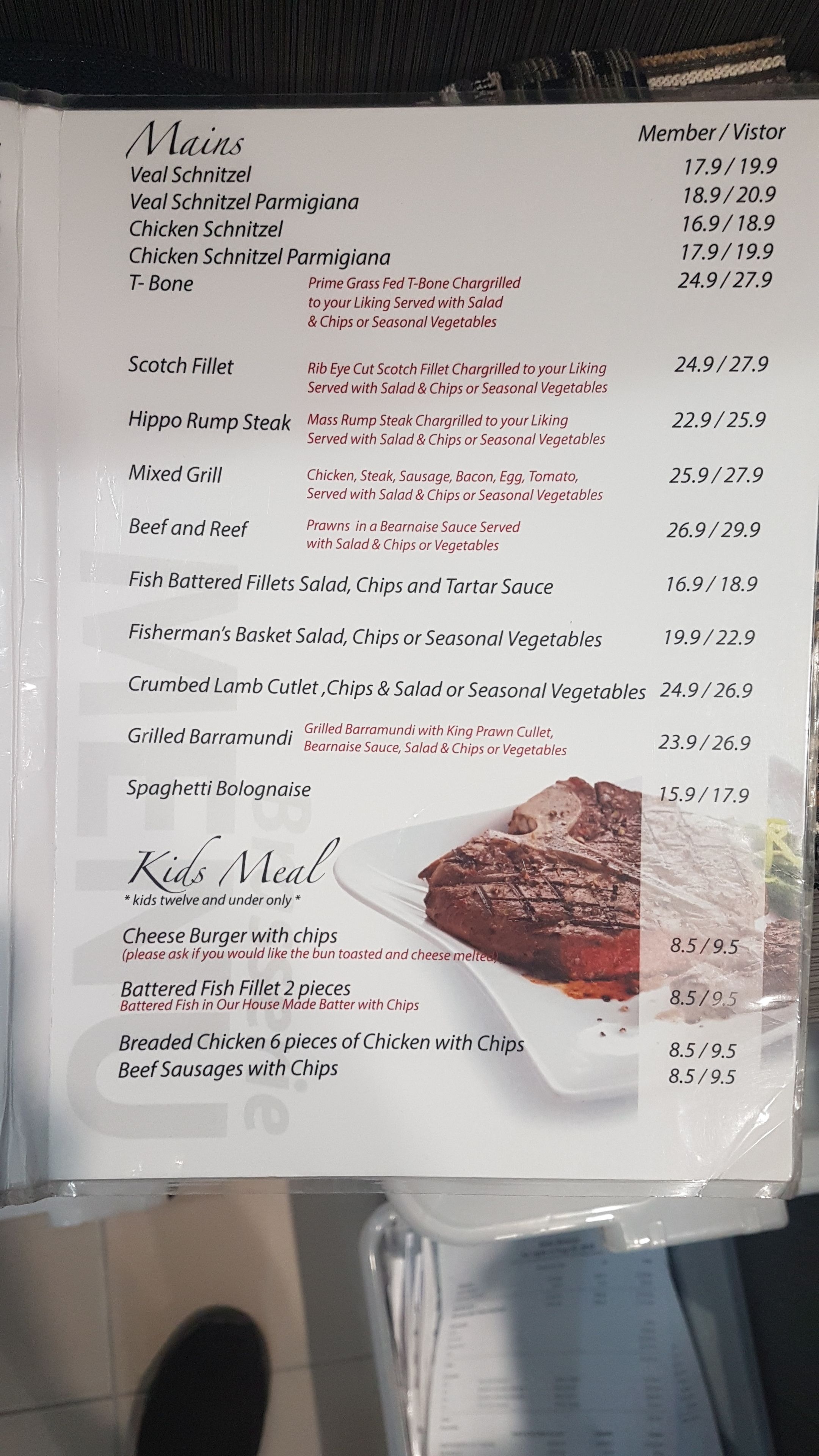A restaurant menu listing various dishes with prices for members and visitors.