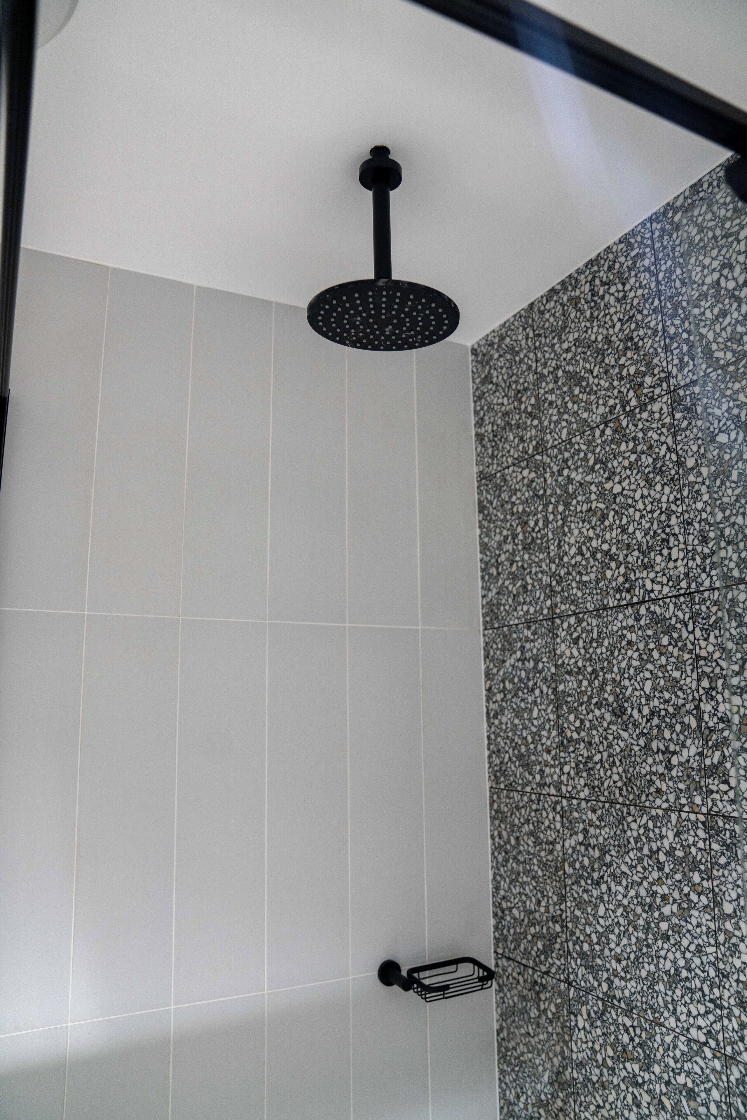 deluxe studio suite | bathroom | shower, free toiletries, hair dryer, towels