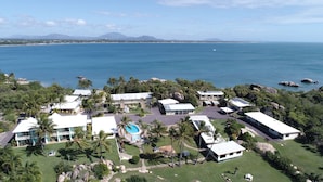 A coastal resort with multiple buildings, a swimming pool, and a view of the ocean. - Whitsunday Sands Resort (Bowen)