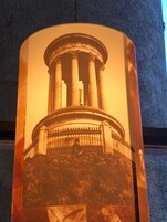 A cylindrical column with a classical architectural design, possibly part of a larger structure.