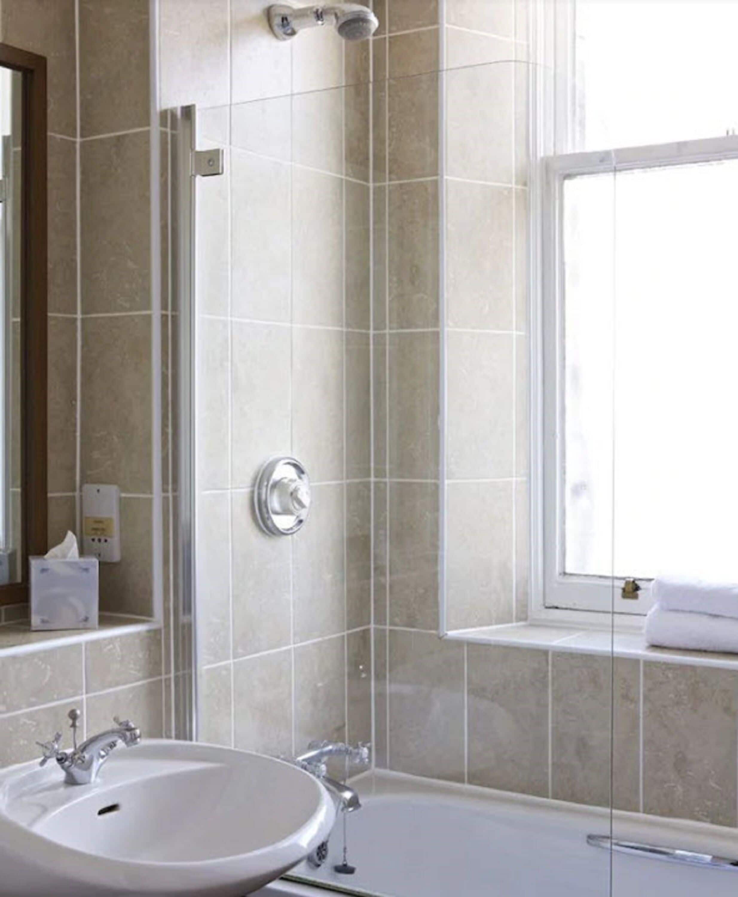 designer toiletries, hair dryer, towels