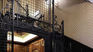 A staircase with ornate black metal railings and a patterned carpet. - Parliament House Hotel (Edinburgh)