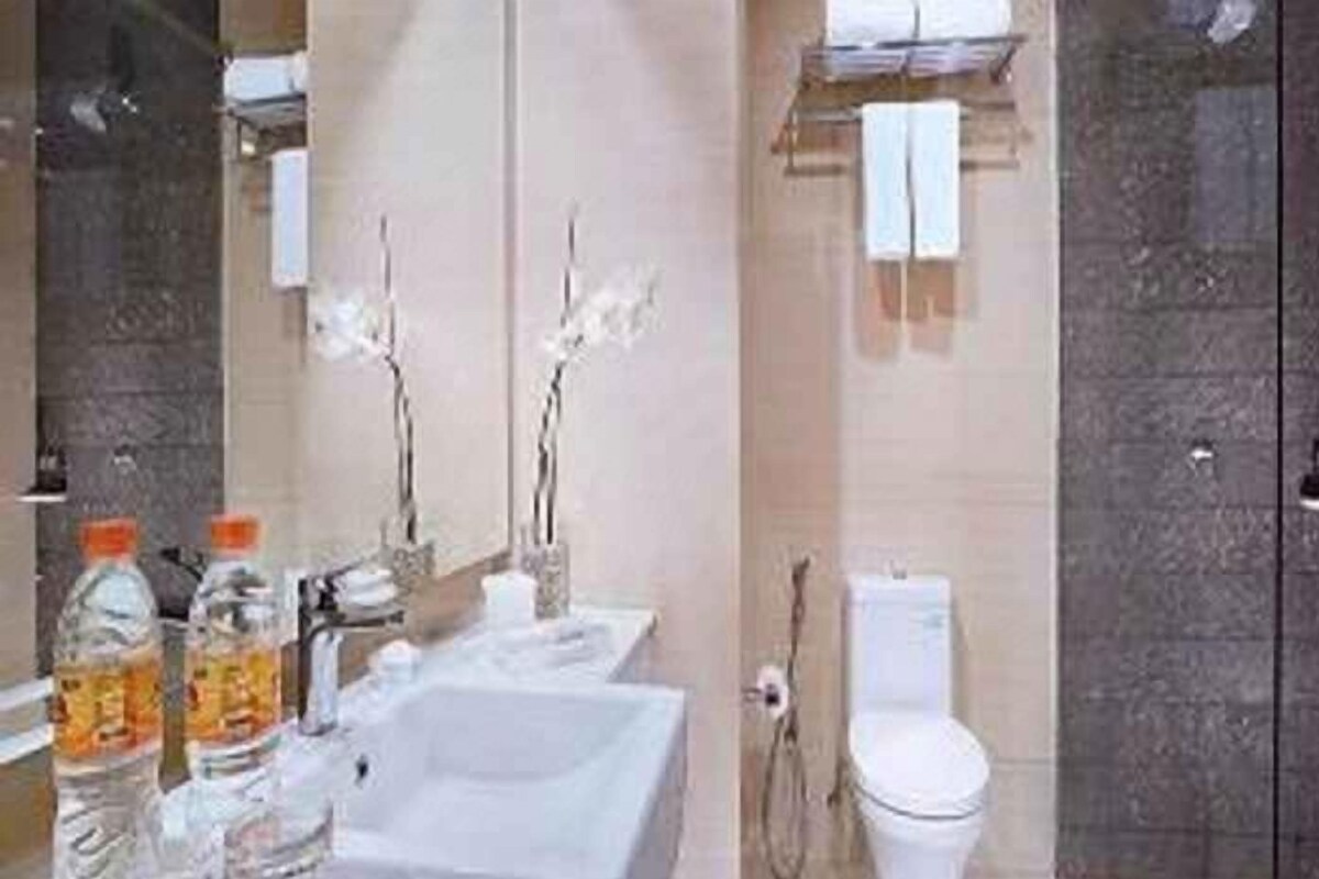 A bathroom with a bathtub, a toilet, and a sink.