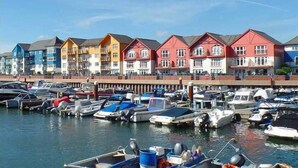 A marina with colorful buildings and boats docked.
