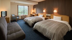 A hotel room with two beds, a sofa, a desk, a TV, and a large window offering a view of the outdoors. - Hanamaki Onsen Hotel Senshukaku (Hanamaki)