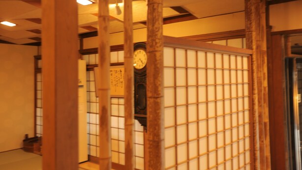 A traditional Japanese room with tatami flooring, a shoji screen, and a clock on the wall. - Kaichoen (Yonago)