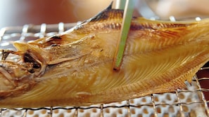 A dried fish on a wire rack.