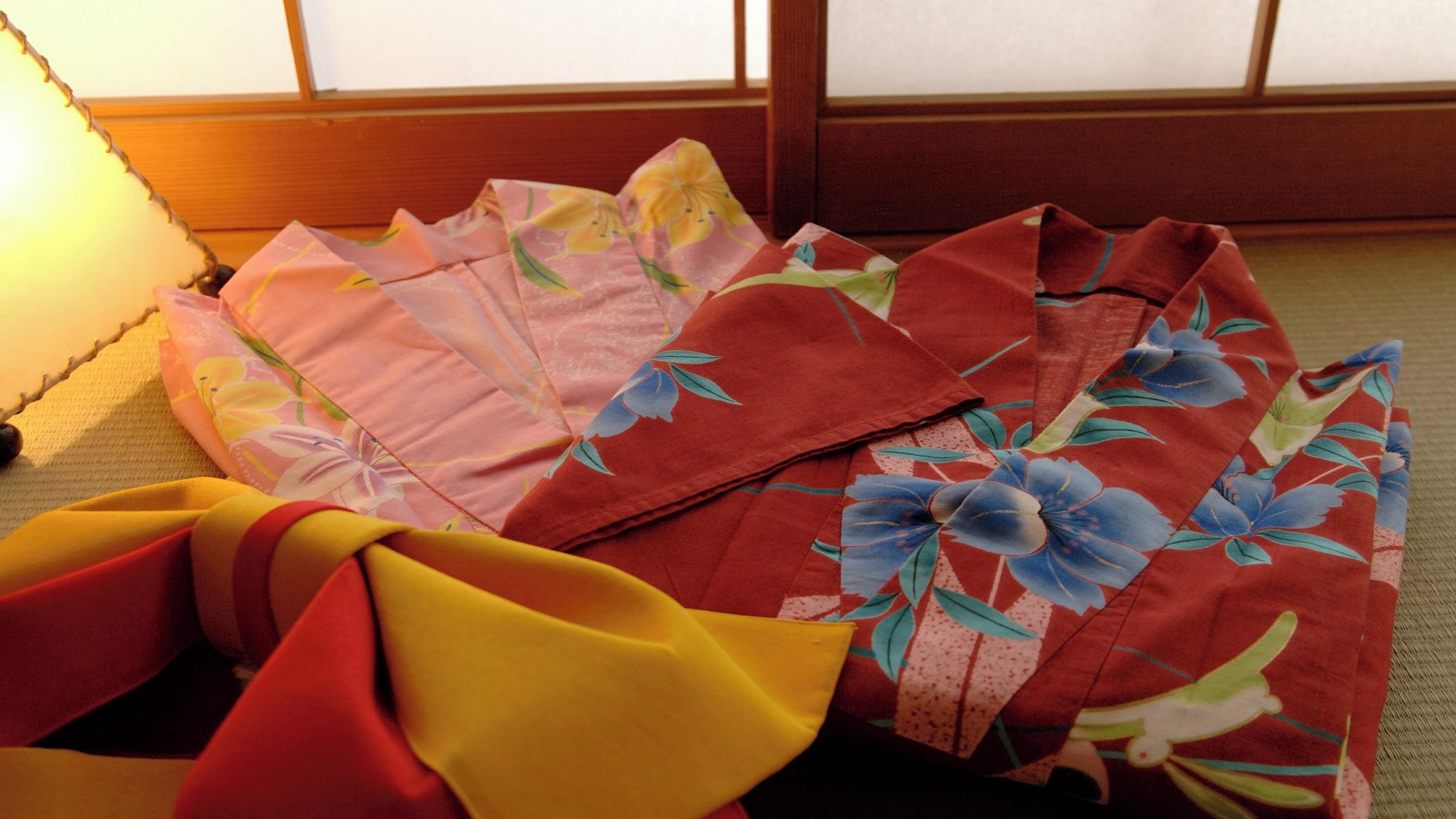 A traditional Japanese room with tatami flooring and a shoji screen in the background.