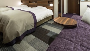 A hotel room with two beds, a round wooden table, and a purple sofa. - Kochi Pacific Hotel (Kochi)