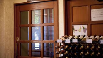 A wooden door labeled "Dining Room" with a wine rack filled with bottles.