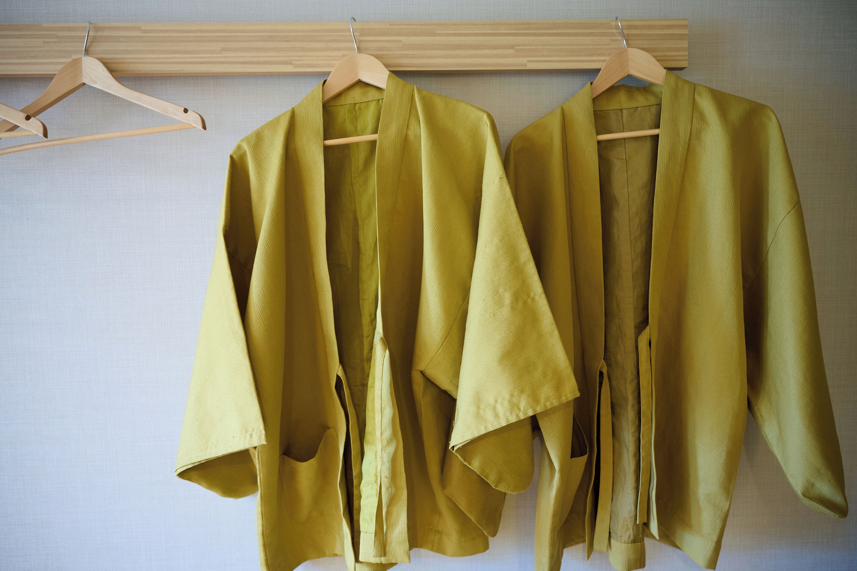 A wooden hanger with a garment.