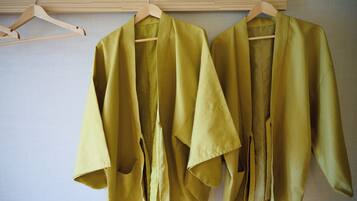 A wooden hanger with a garment.