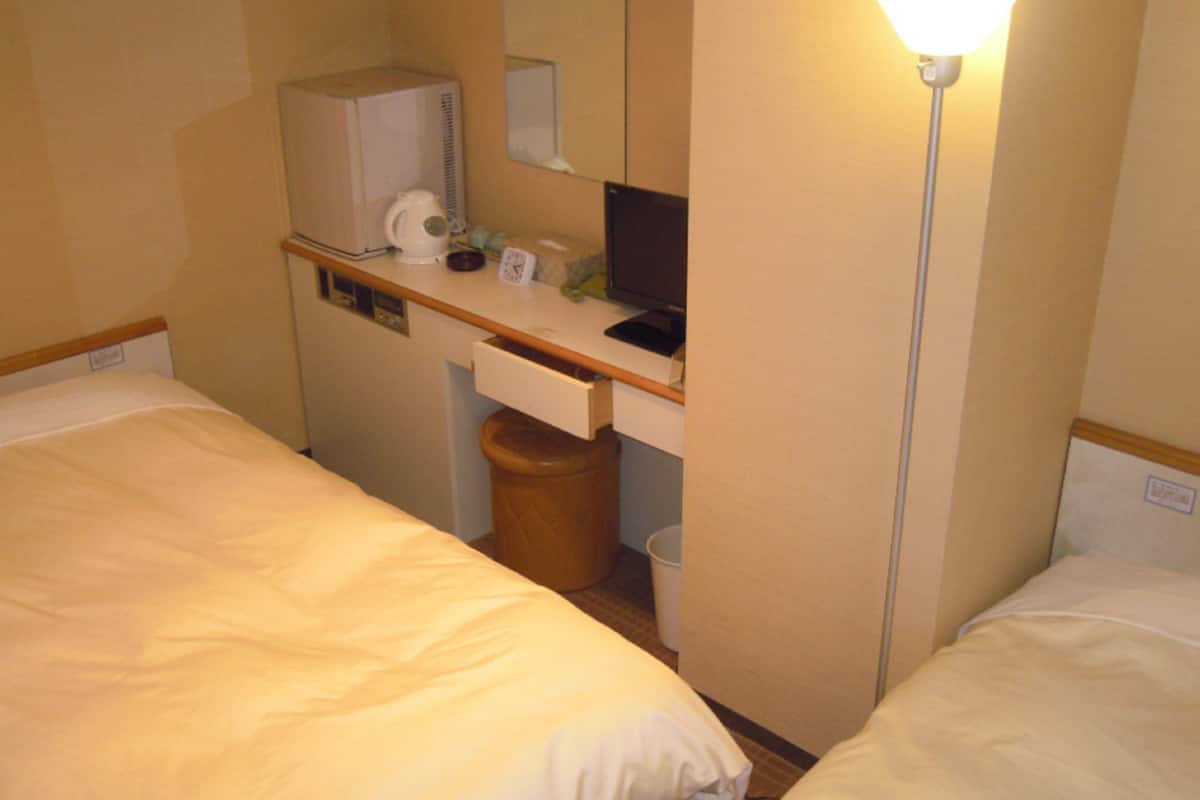 compact twin room | premium bedding, desk, blackout curtains, iron/ironing board