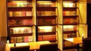 A library with multiple bookshelves and reading tables. - Niigata Park Hotel (Niigata)
