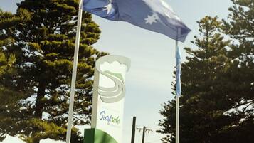 A sign for a location named 'Surfside' with a logo featuring a wave and a mountain.