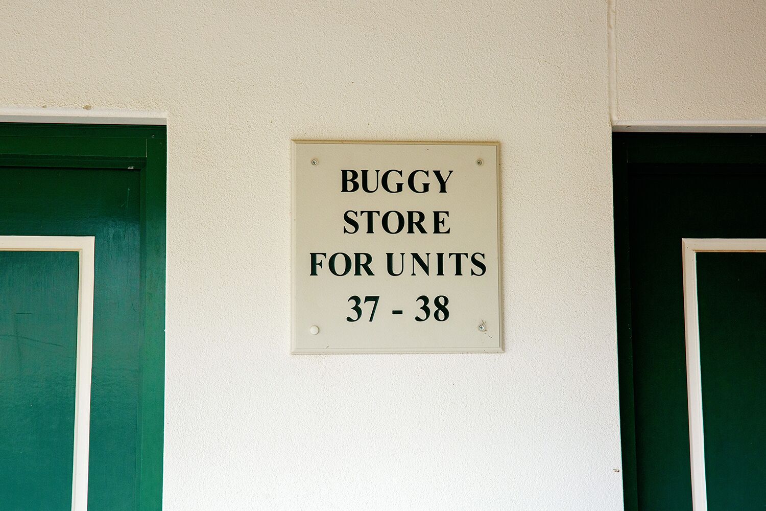 A sign on a wall indicating a 'BUGGY STORE FOR UNITS 37 - 38'.