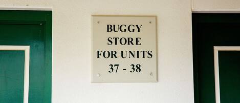 A sign on a wall indicating a 'BUGGY STORE FOR UNITS 37 - 38'.