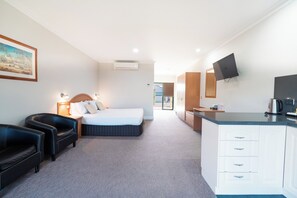 A hotel room with a bed, a desk, a chair, a television, and a painting on the wall. - Yarrawonga Mulwala Golf Club Resort (Mulwala)