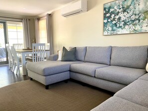 2 Bedroom Deluxe Garden View 5 | Living area | 42-inch flat-screen TV with cable channels, TV, DVD player - Winbi River Resort Holiday Rentals (Moama)