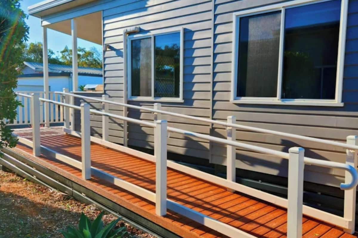A house with a wooden deck and a white railing.