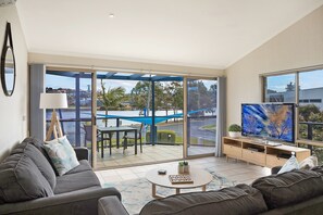 Three Bedroom Apartment with Lake View | Living area | Plasma TV, DVD player - Sails Luxury Apartments Merimbula (Merimbula)