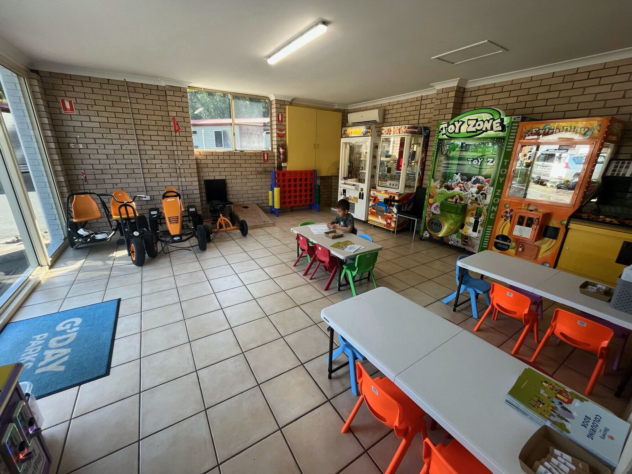 A children's play area with tables, chairs, and various play equipment.