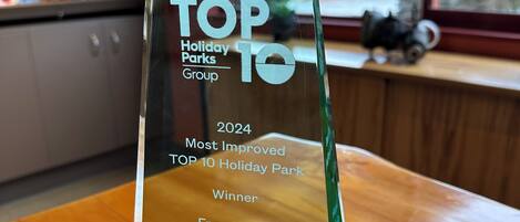 Una placa de premio de cristal transparente sobre una mesa de madera.
