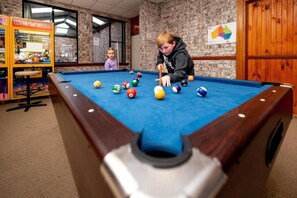 A pool table with balls in a room with brick walls and wooden doors. - BIG4 Mudgee Holiday Park (Mudgee)