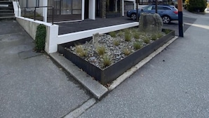 A modern multi-story building with a sign for Lakeside Luxury Apartments. - Lakeside Motel - Queenstown (Queenstown)