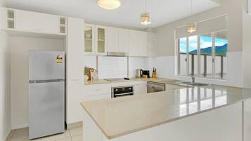 Fridge, microwave, coffee/tea maker, cookware/dishes/utensils