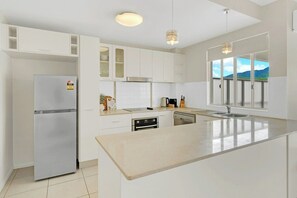Fridge, microwave, coffee/tea maker, cookware/dishes/utensils